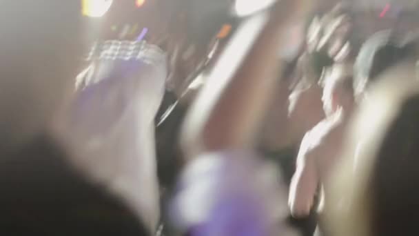 SAINT PETERSBURG, RUSSIA - JUNE 26, 2015: People dancing, push each other at live performance in nightclub. Spotlights. Topless men. Crazy — Stock Video
