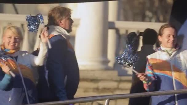 SAINT PETERSBURG, RUSSIA - OCTOBER 27, 2013: Relay race of Olympic flame in Saint Petersburg in October. Happy girls in bus wave pom pom. Uniform — Stock Video