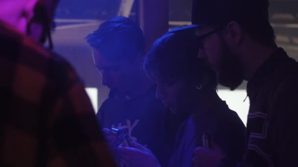 SAN PETERSBURG, RUSIA - 28 DE MAYO DE 2016: Los fumadores prueban un nuevo líquido en el cigarrillo electrónico. Un club nocturno. Proyectores. Vapers. — Vídeos de Stock