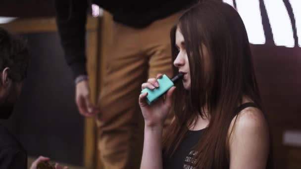 SAINT PETERSBURG, RUSSIA - MAY 28, 2016: Girl exhalation steam from blue electronic cigarette at stage. Festival vapers — Stock Video