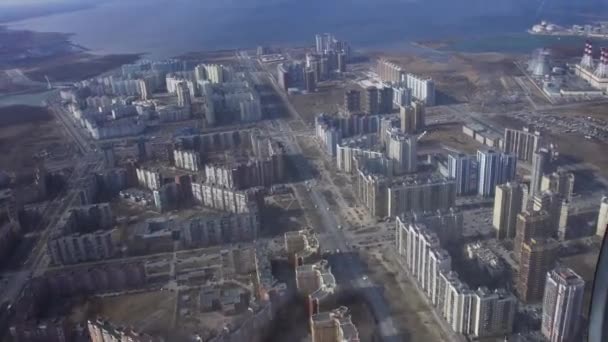 Aerial view from flying helicopter. Camera inside. Landscape of city at coast. Modern skyscrapers. — Stock Video