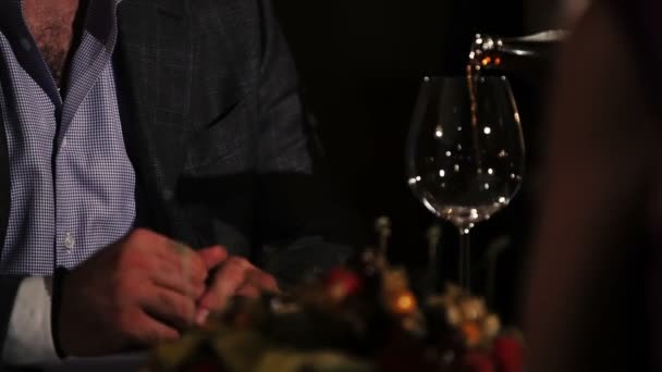 Man in jacket, shirt sitting at table in restaurant with woman. Waiter pour coke — Stock Video