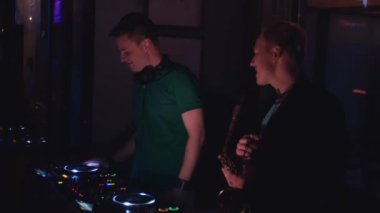 Dj ve saksafon erkekle düet gerçekleştirmek partisi gece kulübünde. Müzisyenler.
