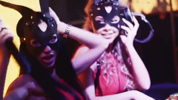 Mc girl and Dj girl in hare masks dance at turntable in nightclub. Performance. — Stock Video