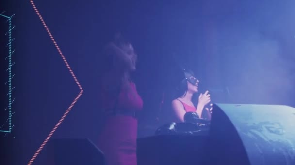 Dj girl and mc girl dance at turntable in nightclub. Jump. Energy. Illuminations — Stock Video