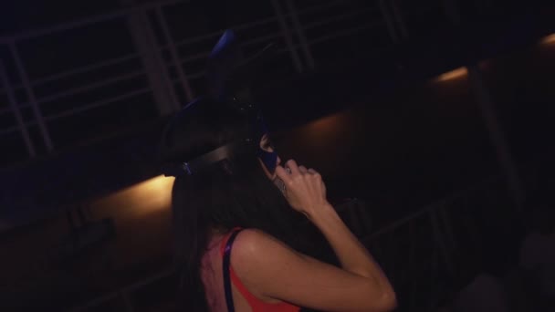 Sexy mc girl in hare mask red bodysuit on stage in nightclub. Show girl. — Stock Video