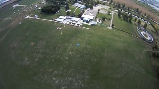 Parachutist mendarat di lapangan hijau. Olahraga aktif yang ekstrim. Adrenalin. Skydiver — Stok Video