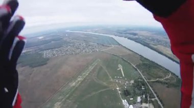 Yeşil alan üzerinde gökyüzü Skydiver sinek nehir. Paraşüt. Aşırı spor. Bulutlu.
