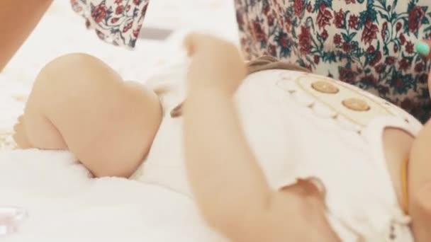 Jonge moeder kiss kleine baby met blauwe ogen. Moederschap. Zorg. Liefde. — Stockvideo