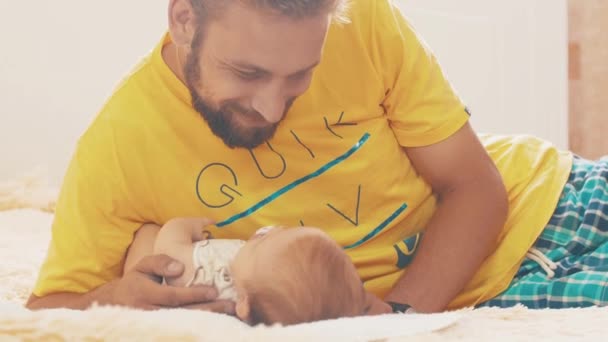 Bearded father lie with little baby. Parent. Family. Communication. Happiness — Stock Video