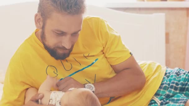 Bearded father lie with little baby. Parent. Family. Communication. Fatherhood — Stock Video