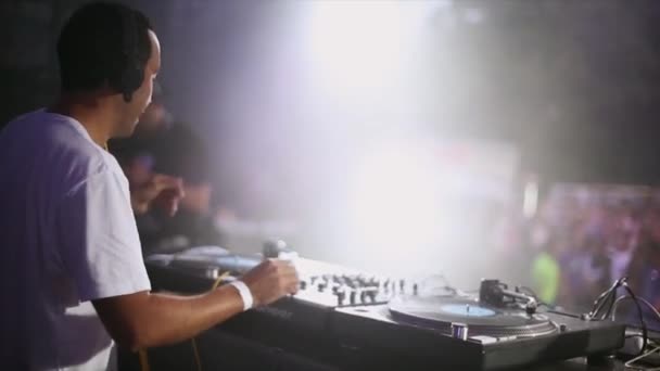 DJ in headphones spinning at turntable — Stock Video