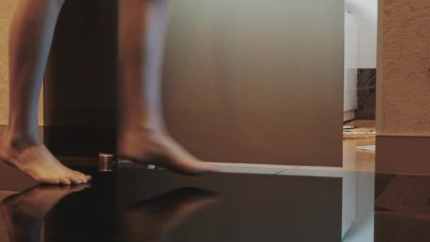 Blick auf Frau elegant ins Badezimmer kommen offene Tür und setzen sich auf weiße Badewanne. — Stockvideo