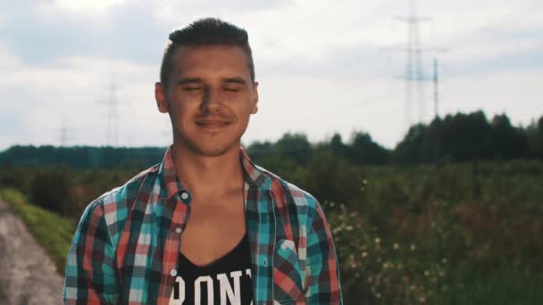 Young boy in plaid shirt serious look in camera on street. Summer sunny day. — Wideo stockowe