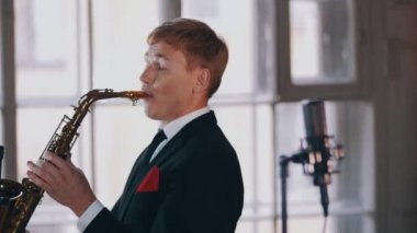 Young saxophonist play on golden saxophone. Live performance. Jazz artist.