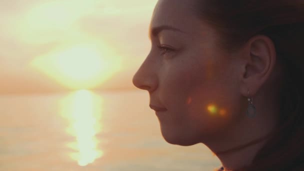 Red hair girl in turquoise dress sail on motor boat. Beautiful sunset. Sun beams — Stock Video