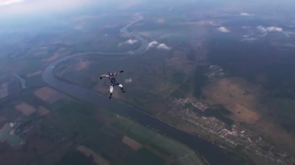 Skydiver free style in evening cloudy sky. Speed. Extreme sport. Falling. Land — Stock Video