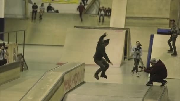 KRASNOYARSK, RUSIA - 15 DE MARZO DE 2014: El patinador salta de la valla, pierde el sombrero. Un trampolín. Truco extremo. Competencia en skatepark — Vídeos de Stock