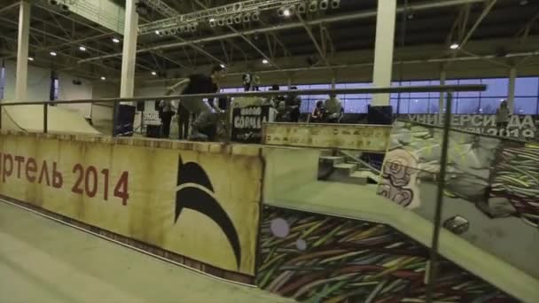 KRASNOYARSK, RUSSIE - 15 MARS 2014 : Le patineur à roulettes saute sur une clôture pour faire un cascade, mais tombe. Un tremplin. Extrême. Compétition en skatepark — Video