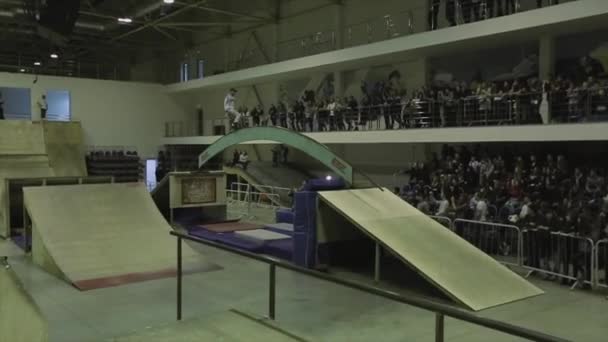 Krasnojarsk, Rusko-15. března 2014: kolečkové bruslař se otáčejí na zakřivenou klenbu mezi pružnicových desek. Extrémní. Soutěž na skateparku. Lidé — Stock video