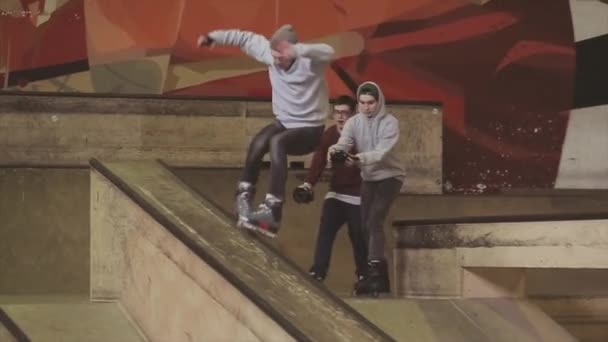 KRASNOYARSK, RUSSIA - MARCH 15, 2014: Several cameraman shoot roller skater slide on springboard. Get hard spill. Competition in skatepark — Stock Video