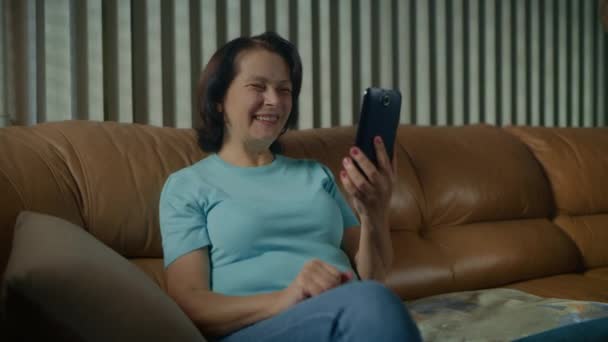 Äldre kvinna talar med videosamtal med hjälp av en smartphone. — Stockvideo