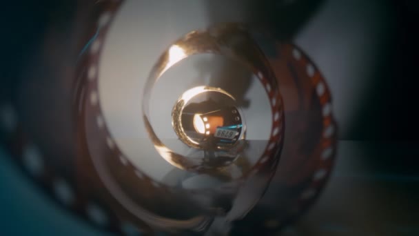 Camera pans through filmstrip. Dolly zoom by macro lense — Stock Video