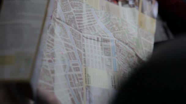 Two people explore map. Tourists looking at a map — Stock Video