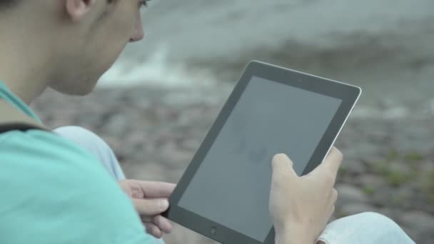 Man using tablet pc at the lake — Stock Video