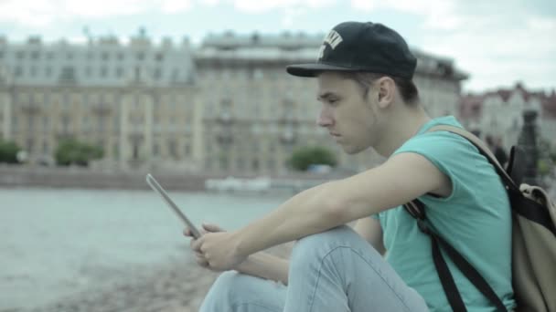 Man using tablet pc at the lake — Stock Video