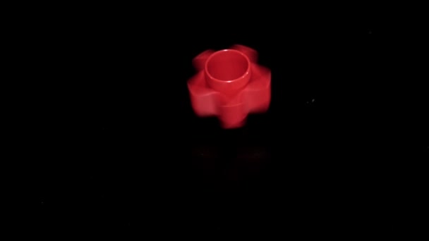 Slowmotion spinning whirligig spinner toy tool on black background — Stock Video