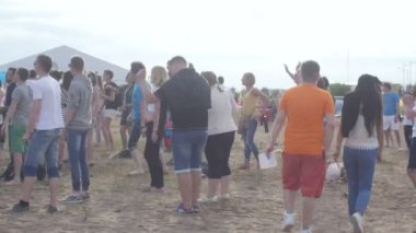 ST. PETERSBURG, RUSSIA - JULY 18, 2015: VK FEST. Open air beach party with music and djs. People dancing at the beach on the sand.