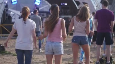ST. PETERSBURG, RUSSIA - JULY 18, 2015: VK FEST. Mad three girls and boys dancing on summer beach party