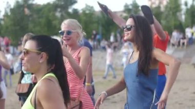 ST. PETERSBURG, RUSSIA - JULY 18, 2015: VK FEST. Girls in shorts and dresses and boys dancing on summer beach disco music dj
