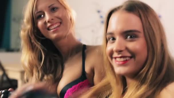 Girls in lingerie playing video games — Stock Video