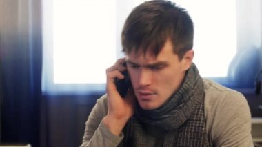 Hastalıklı bir adam görüşmeler telefon, burun üfleme. Dinamik atış