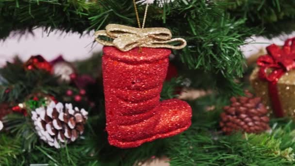 Decoration of Christmas tree red boot. Pan — Stock Video