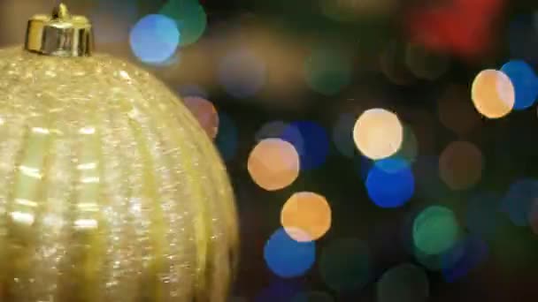 Big golden ball rotates at background bokeh — Stock Video