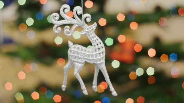 Christmas deer toy shakes at background bokeh — Stock Video