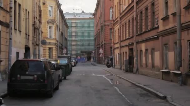 View of city street with signs and cars in summer evening. Camera moves forward — Stock Video