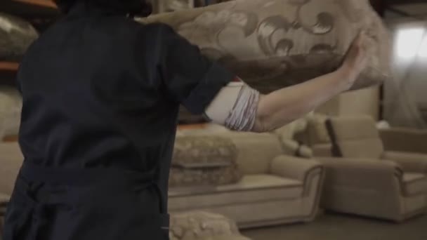 Woman in work form shifts parts of sofa in furniture factory — Stock Video