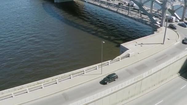 Quadrocopter schiet brug-, rivier- en wegvervoer in zonnige zomerdag. Slow motion — Stockvideo