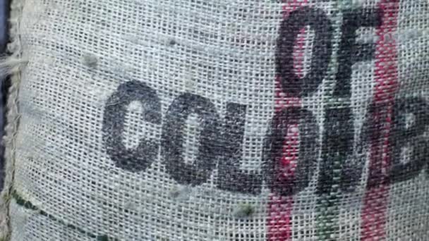 Bag with coffee grains in coffee factory.  Inscription product of Colombia. — Stock Video