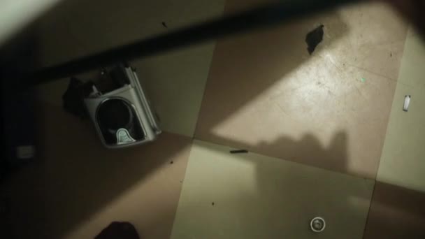 Ο άνθρωπος σαρώνει θραύσματα από σπασμένο παίχτη δίσκο στο πάτωμα με σκούπα. Κορυφαία προβολή — Αρχείο Βίντεο