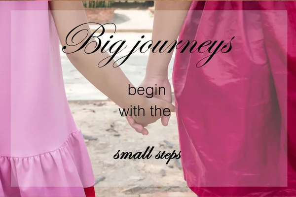 Word  Big journeys begin with the small steps.Inspirational motivational quote on little kids couple holding hands background — Stock Photo, Image