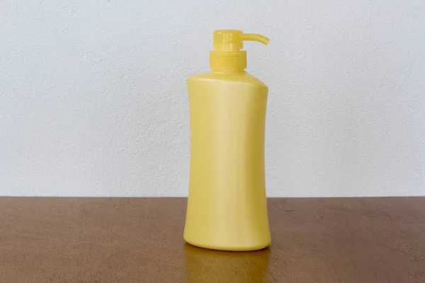 Yellow bottles of health and beauty products cosmetic on the wood