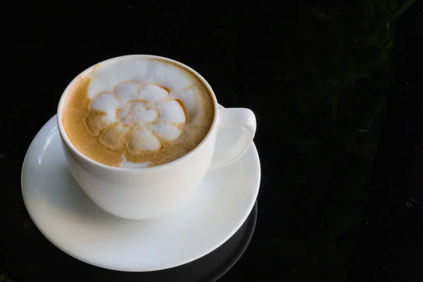 Mavi fincan kahve, latte siyah cam masa üzerinde kapatın — Stok fotoğraf