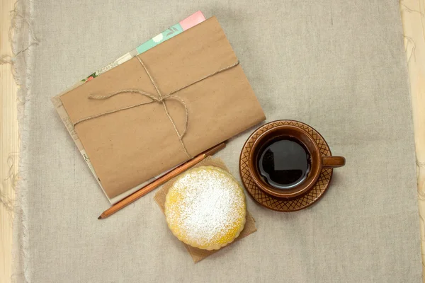 Homemade milk biscuits, a cup of coffee and notepad on  napkin — Stock Photo, Image