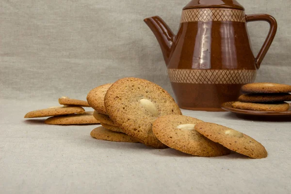 Homemade macaroons round and brown ceramic coffee pot