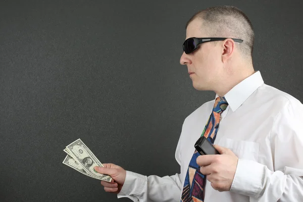 Business man reaches out with dollars — Stock Photo, Image